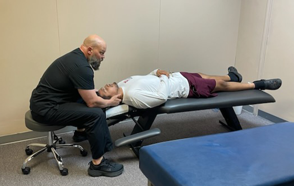 Auto Injury Chiropractor Grand Prairie TX Cameron Steadham Adjusting Patient