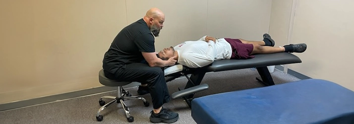 Auto Injury Chiropractor Grand Prairie TX Cameron Steadham Adjusting Patients Neck